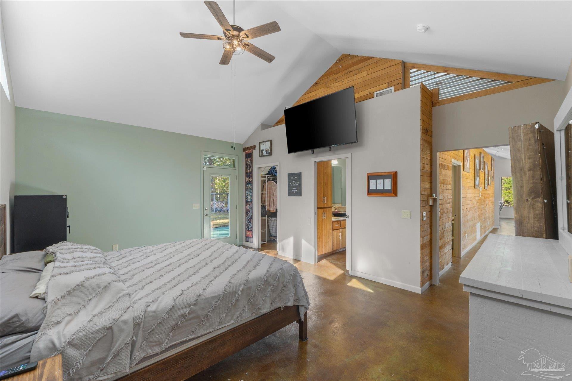 4394 Crabtree Church Road Molino, FL 32577 - Photo 36 of 70 a bedroom with a bed and a flat screen tv