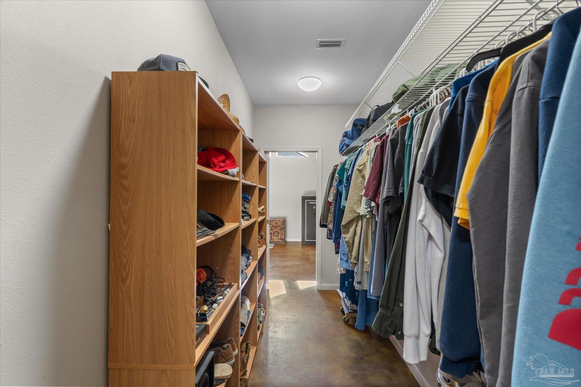 4394 Crabtree Church Road Molino, FL 32577 - Photo 38 of 70 a view of walk in closet with clothes and shoes