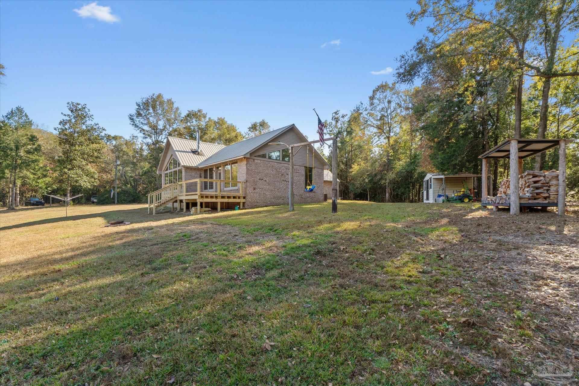 4394 Crabtree Church Road Molino, FL 32577 - Photo 44 of 70 a front view of a house with a yard