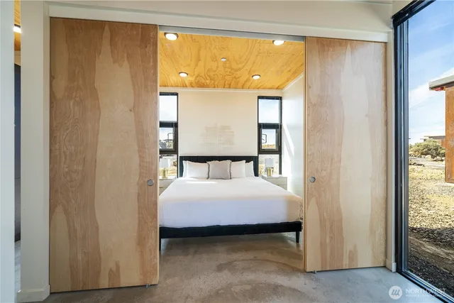 a bedroom with a bed and a window