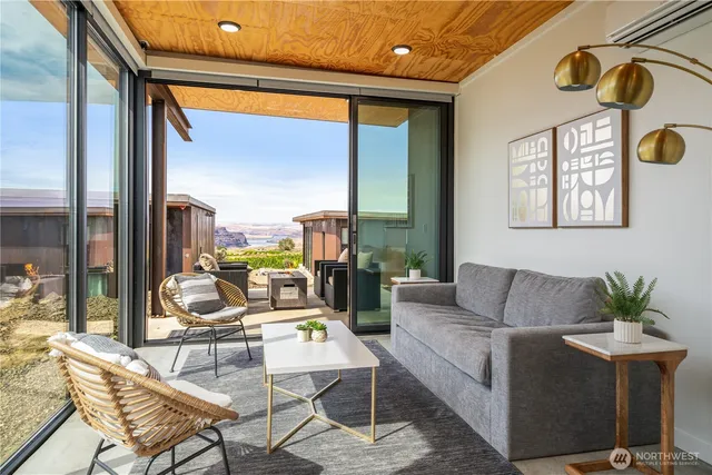a living room with furniture and a floor to ceiling window