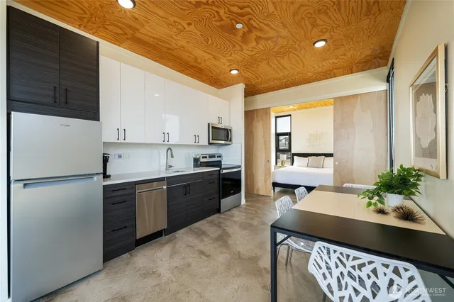 a kitchen with a refrigerator and a sink
