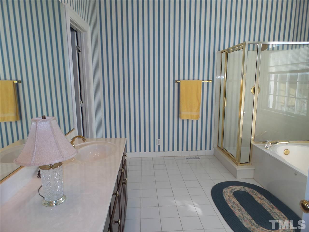 2915 Green Path Road Dunn, NC 28334 - Photo 12 of 24 a view of a bathroom with a tub and sink