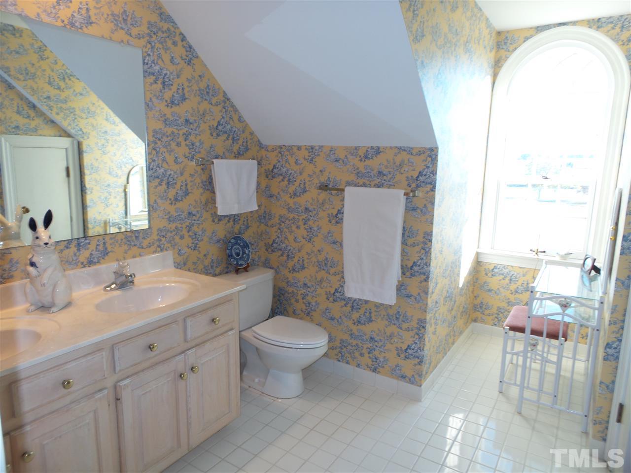 2915 Green Path Road Dunn, NC 28334 - Photo 17 of 24 a spacious bathroom with a double vanity sink toilet and a mirror
