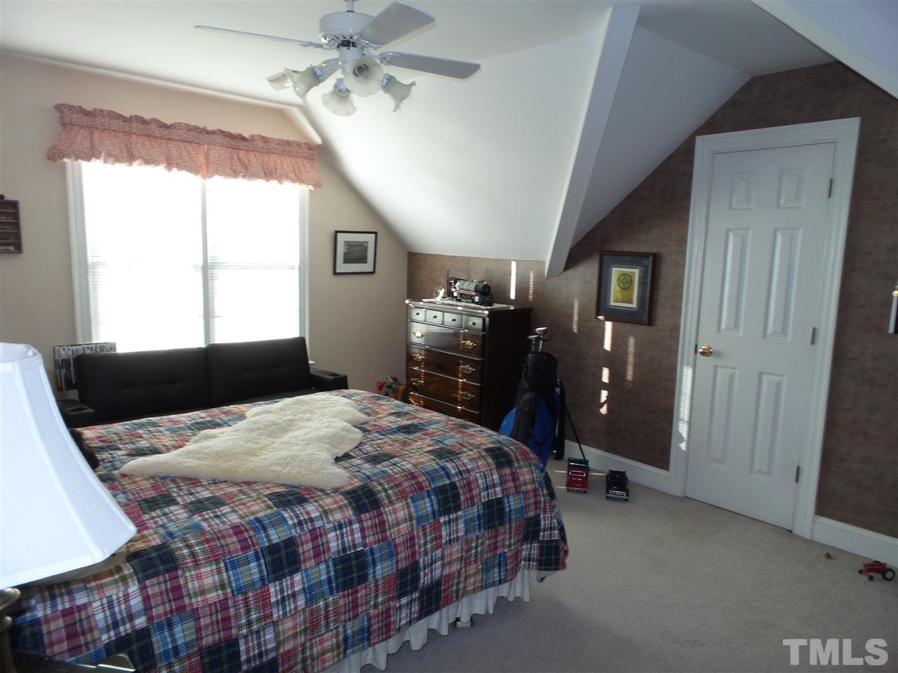 2915 Green Path Road Dunn, NC 28334 - Photo 18 of 24 a bedroom with a bed and wooden floor