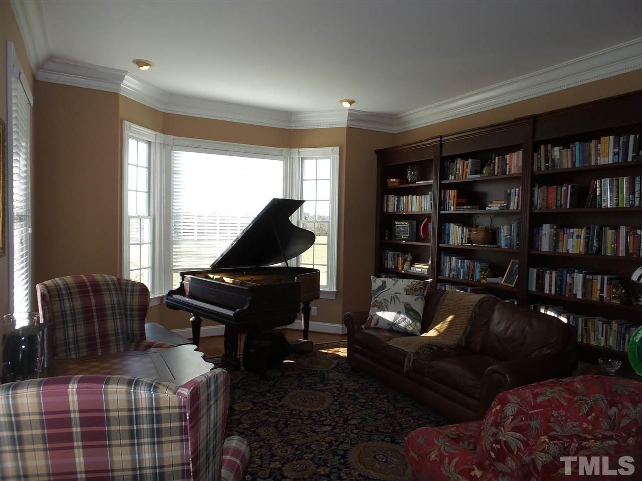 2915 Green Path Road Dunn, NC 28334 - Photo 6 of 24 a living room with furniture and a bookshelf