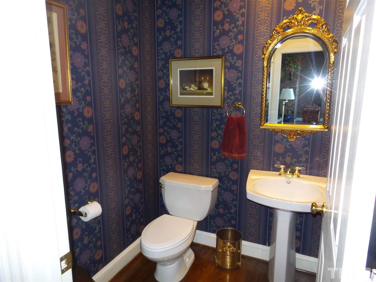 2915 Green Path Road Dunn, NC 28334 - Photo 10 of 24 a bathroom with a toilet a sink and mirror
