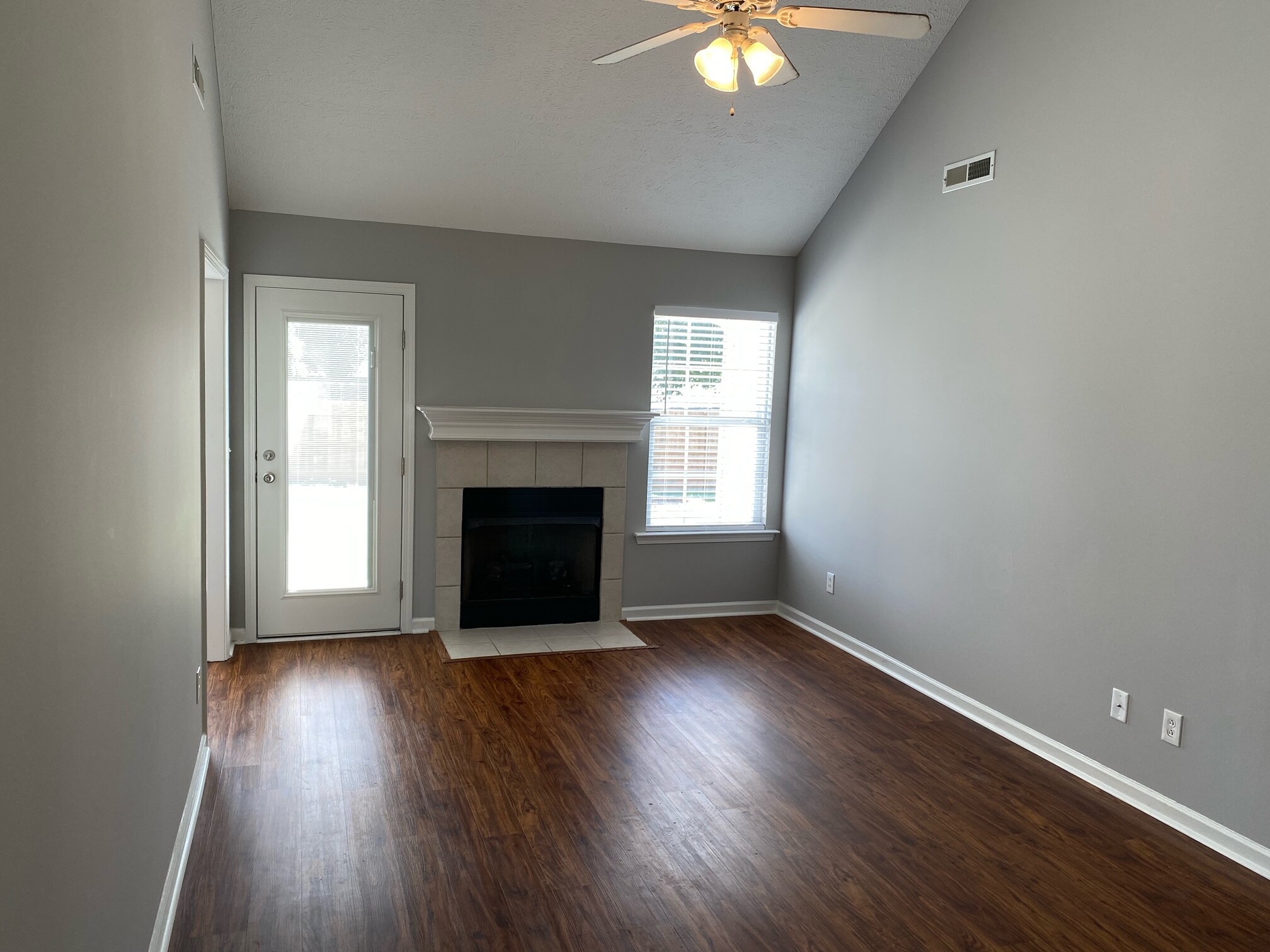 3016 Florence Road Murfreesboro, TN 37129 - Photo 2 of 7 an empty room with wooden floor a fireplace and windows