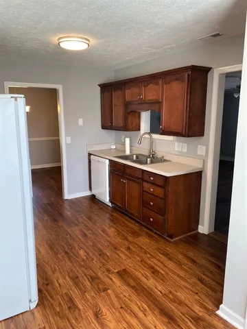 a kitchen with a sink and a refrigerator