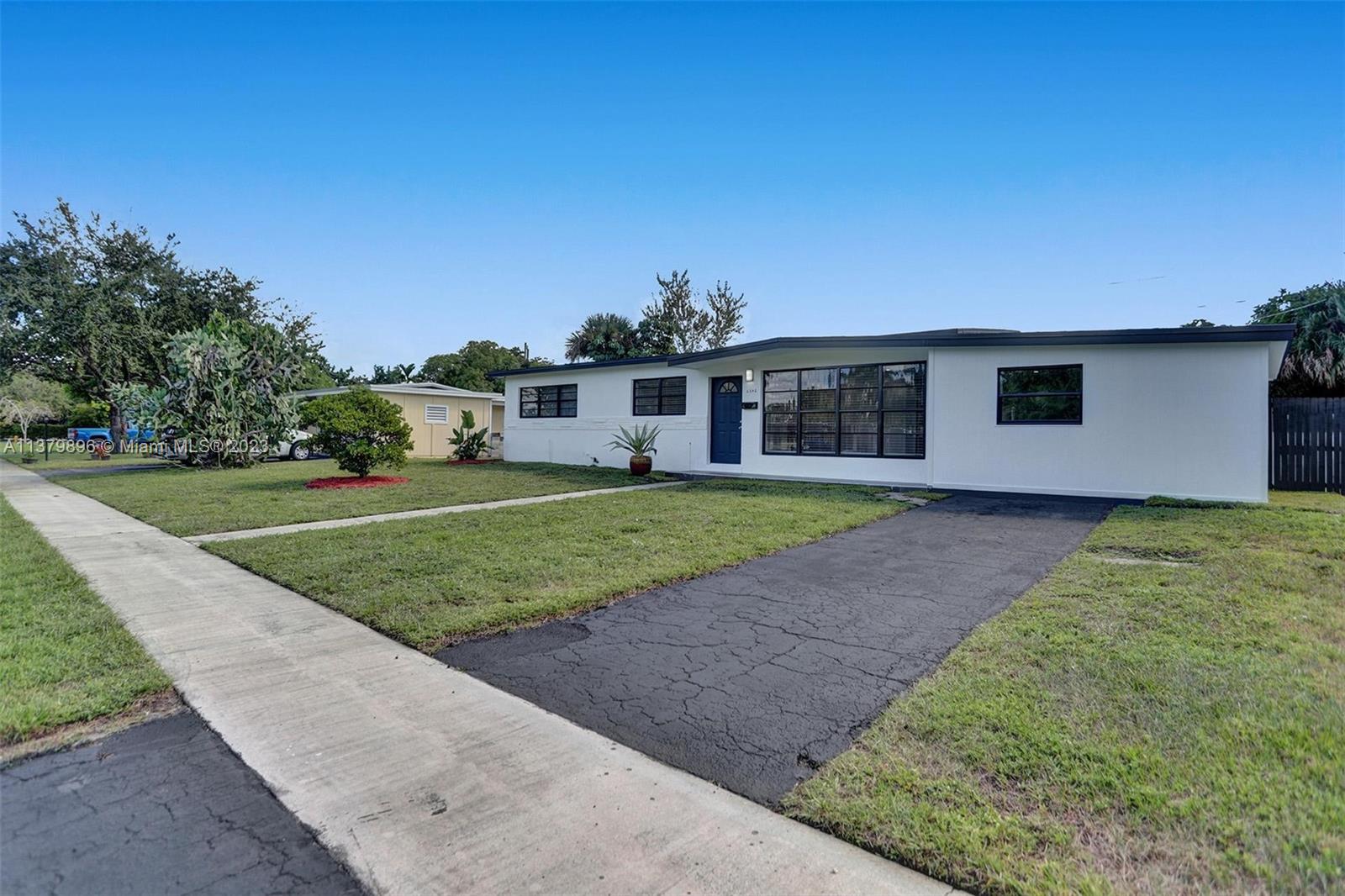 6842 Northwest 13th Street Plantation, FL 33313 - Photo 1 of 33 a front view of a house with a yard and potted plants