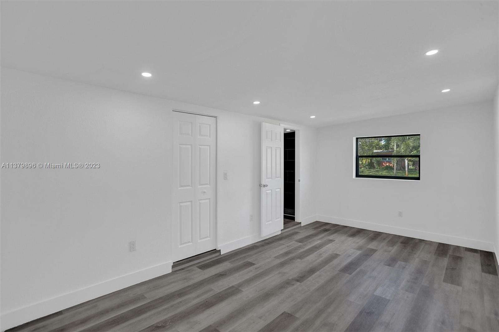 6842 Northwest 13th Street Plantation, FL 33313 - Photo 13 of 33 a view of an empty room with wooden floor