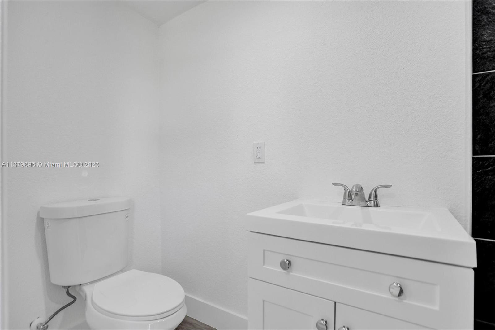 6842 Northwest 13th Street Plantation, FL 33313 - Photo 18 of 33 a bathroom with a sink a toilet and a mirror