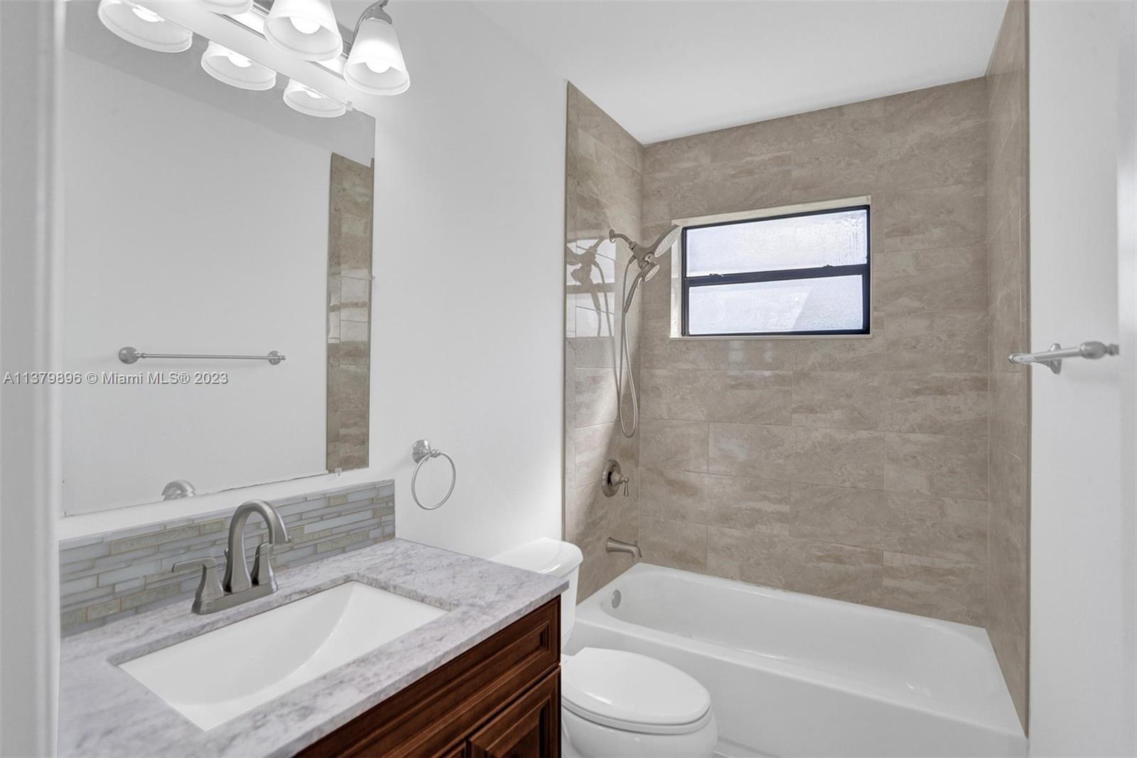 6842 Northwest 13th Street Plantation, FL 33313 - Photo 21 of 33 a bathroom with a granite countertop sink toilet and shower