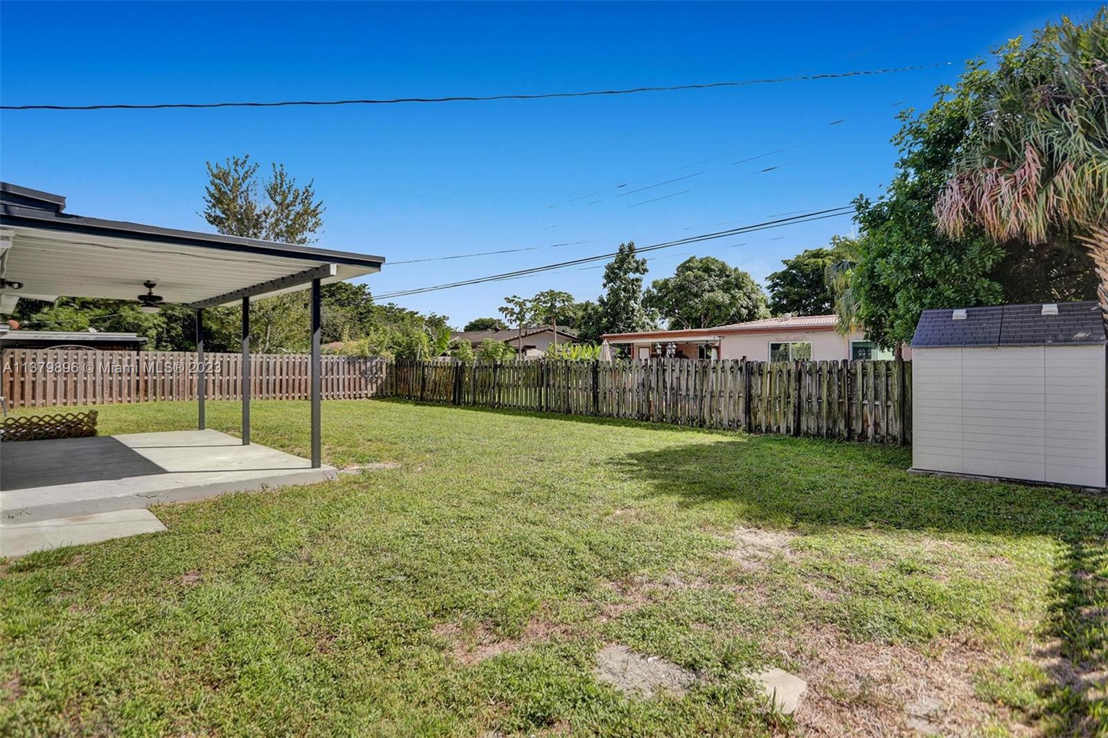 6842 Northwest 13th Street Plantation, FL 33313 - Photo 27 of 33 a view of a backyard with wooden fence
