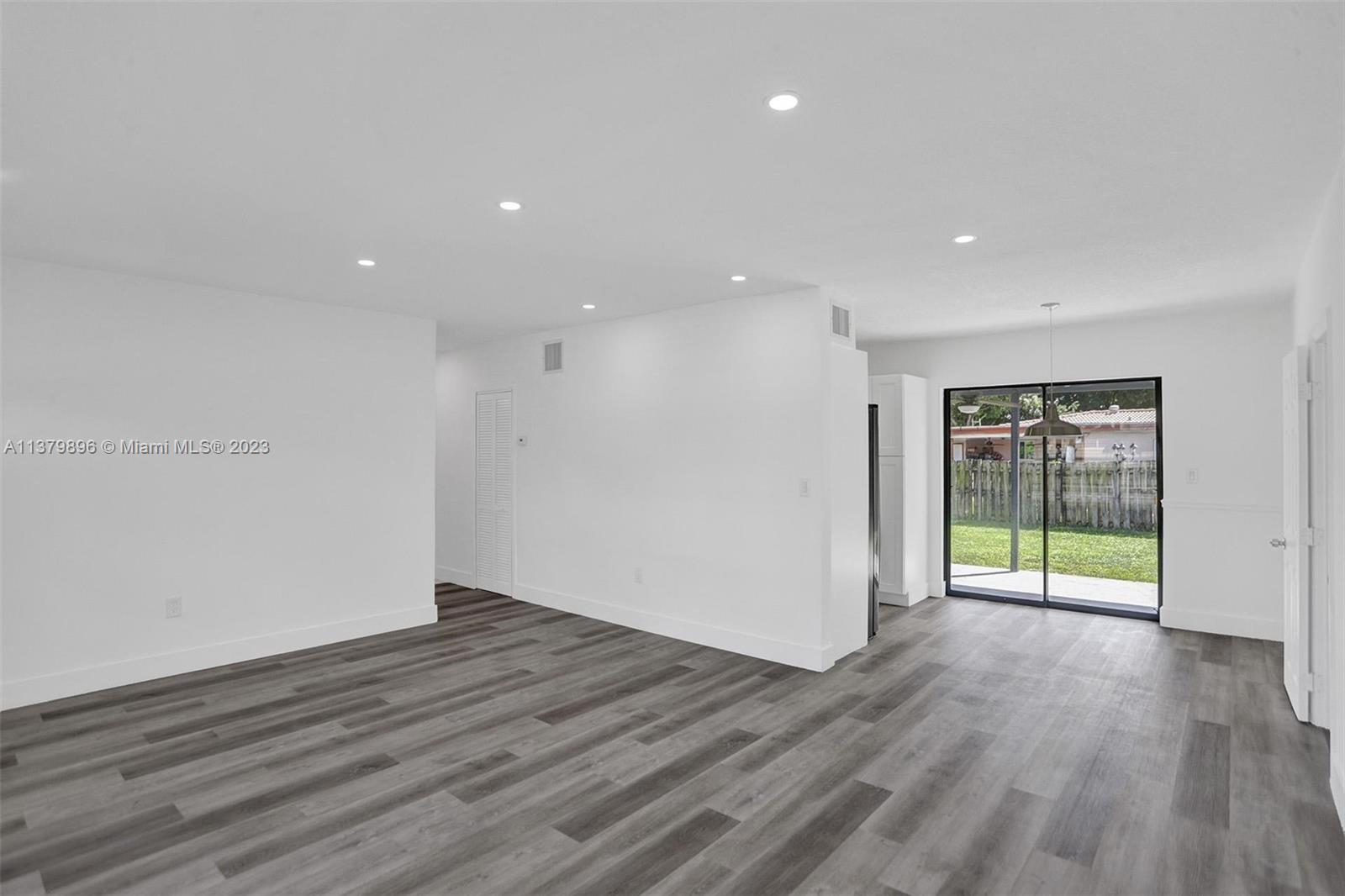6842 Northwest 13th Street Plantation, FL 33313 - Photo 4 of 33 a view of an empty room with wooden floor and a window