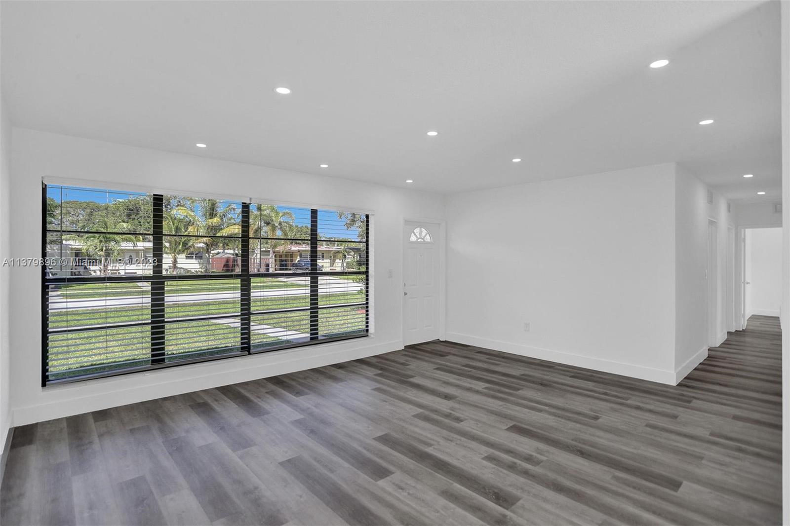 6842 Northwest 13th Street Plantation, FL 33313 - Photo 5 of 33 an empty room with wooden floor and windows
