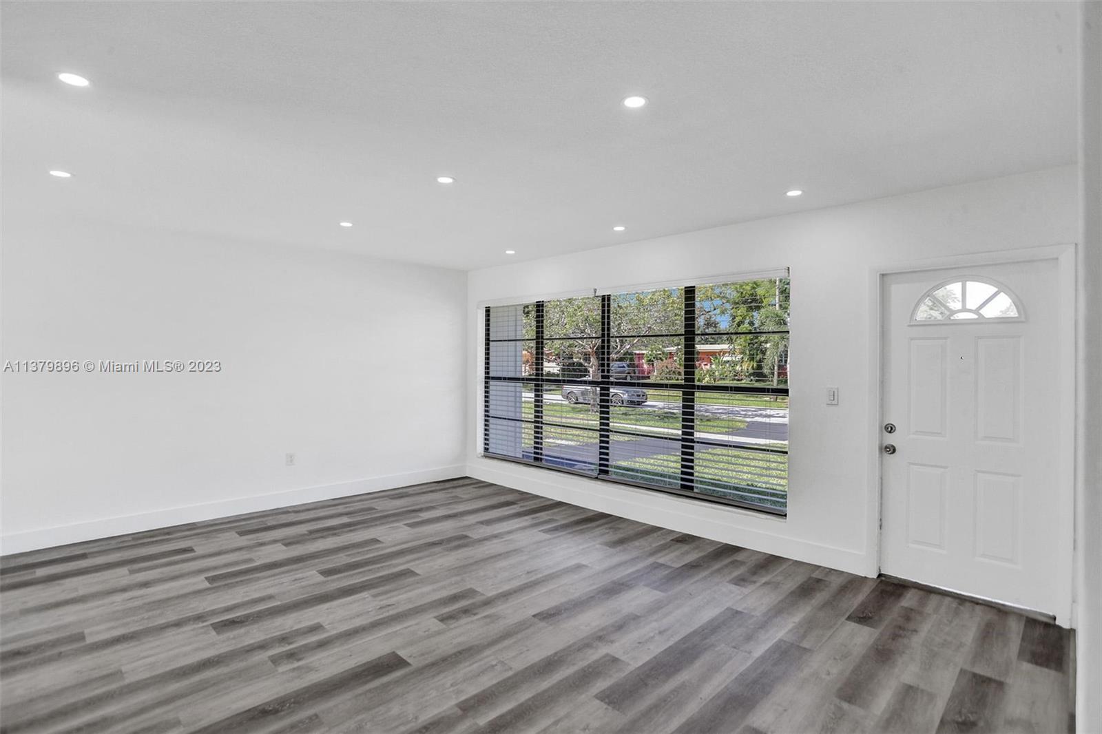 6842 Northwest 13th Street Plantation, FL 33313 - Photo 6 of 33 an empty room with wooden floor and windows