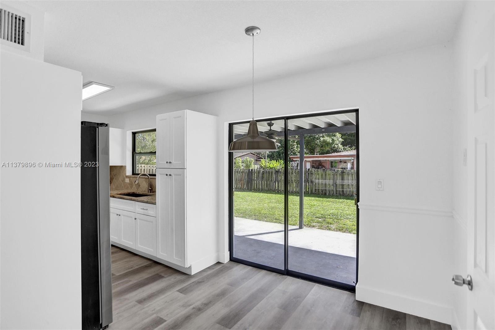 6842 Northwest 13th Street Plantation, FL 33313 - Photo 7 of 33 a view of a kitchen with refrigerator and wooden floor