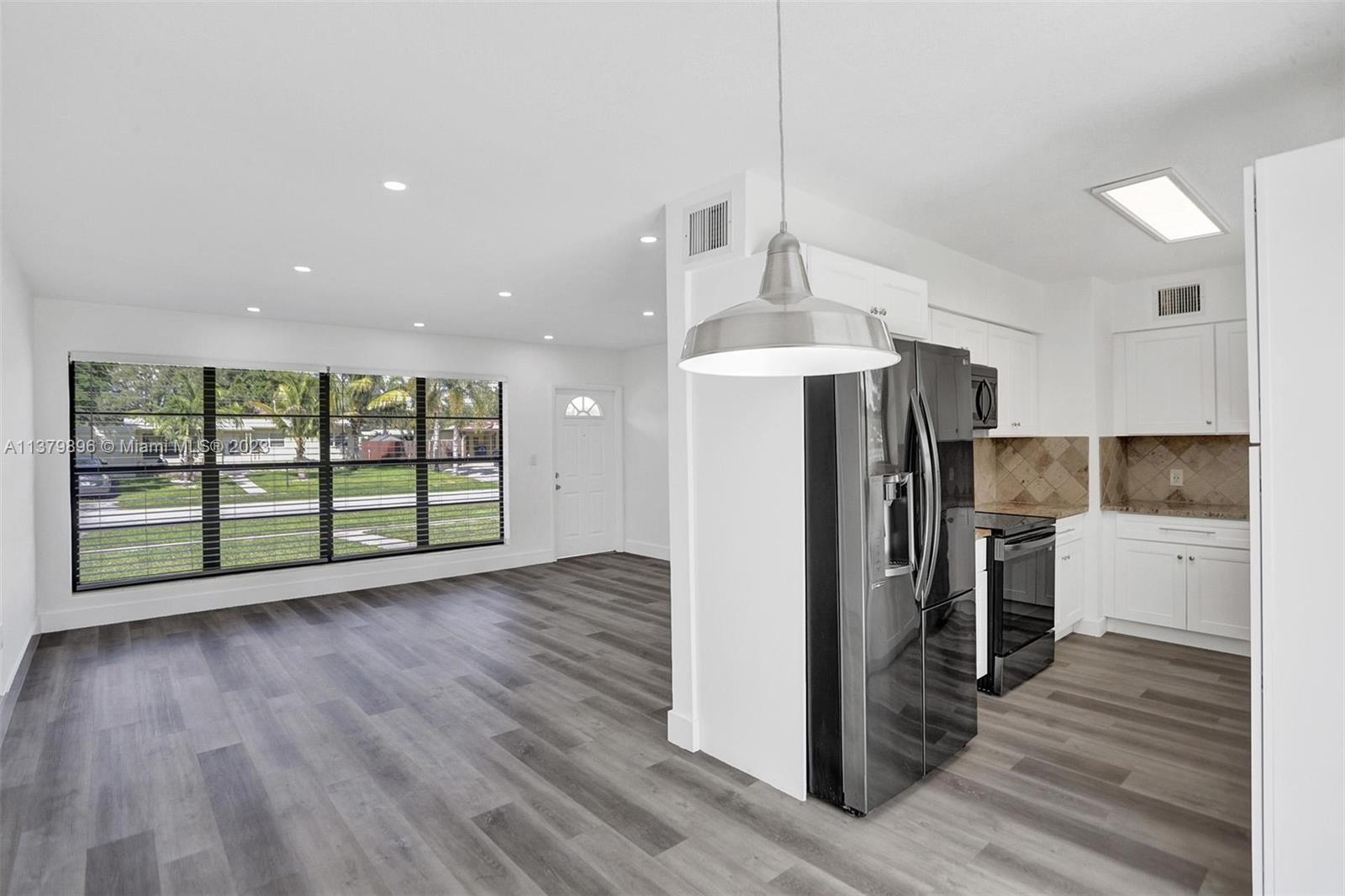 6842 Northwest 13th Street Plantation, FL 33313 - Photo 8 of 33 a open kitchen with stainless steel appliances granite countertop a refrigerator and a stove top oven