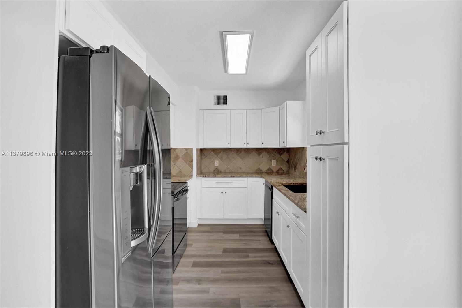 6842 Northwest 13th Street Plantation, FL 33313 - Photo 9 of 33 a kitchen with a refrigerator and a sink