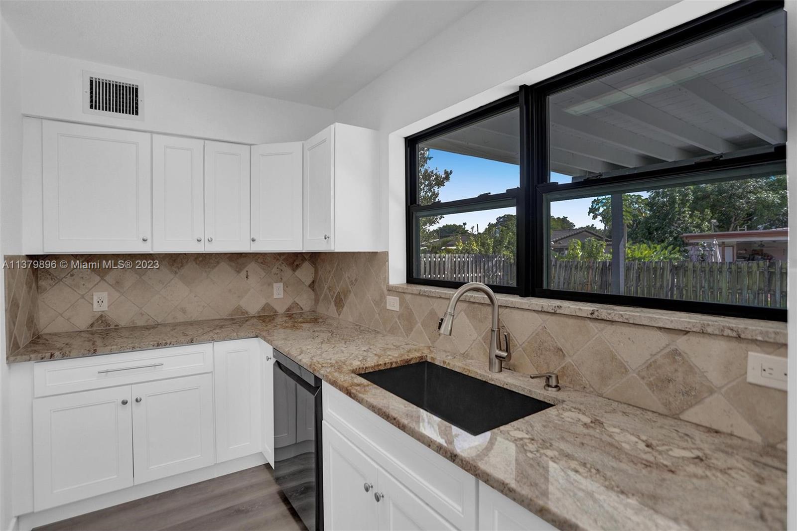 6842 Northwest 13th Street Plantation, FL 33313 - Photo 10 of 33 a kitchen with a sink and cabinets