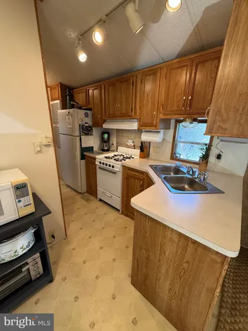 a kitchen with refrigerator and cabinets
