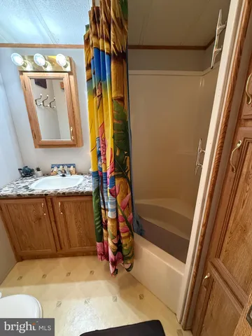 a bathroom with a tub sink and mirror