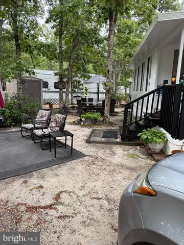 a view of a backyard with sitting area