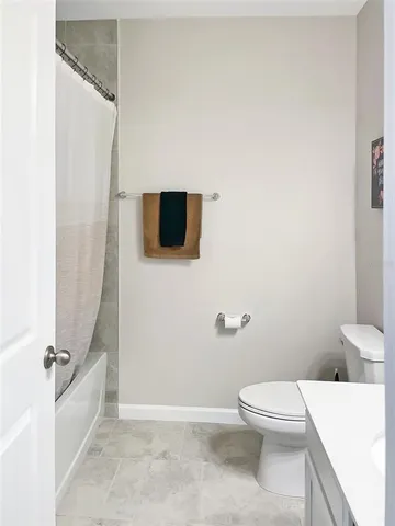 a bathroom with a toilet a sink and a shower