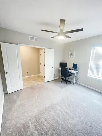 a view of a livingroom with furniture and a window