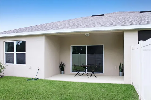 a view of an house with backyard porch and furniture