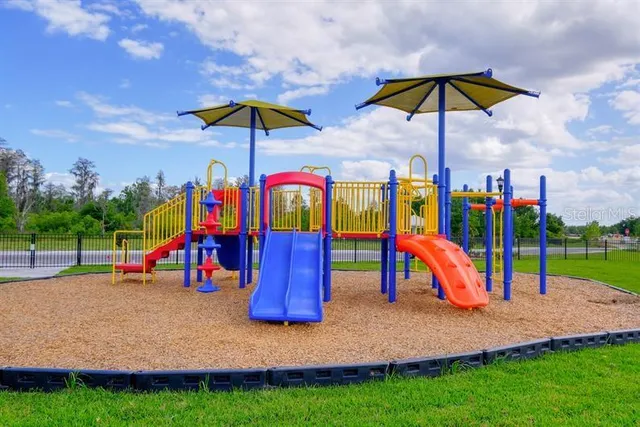 a view of a park with swings and slides