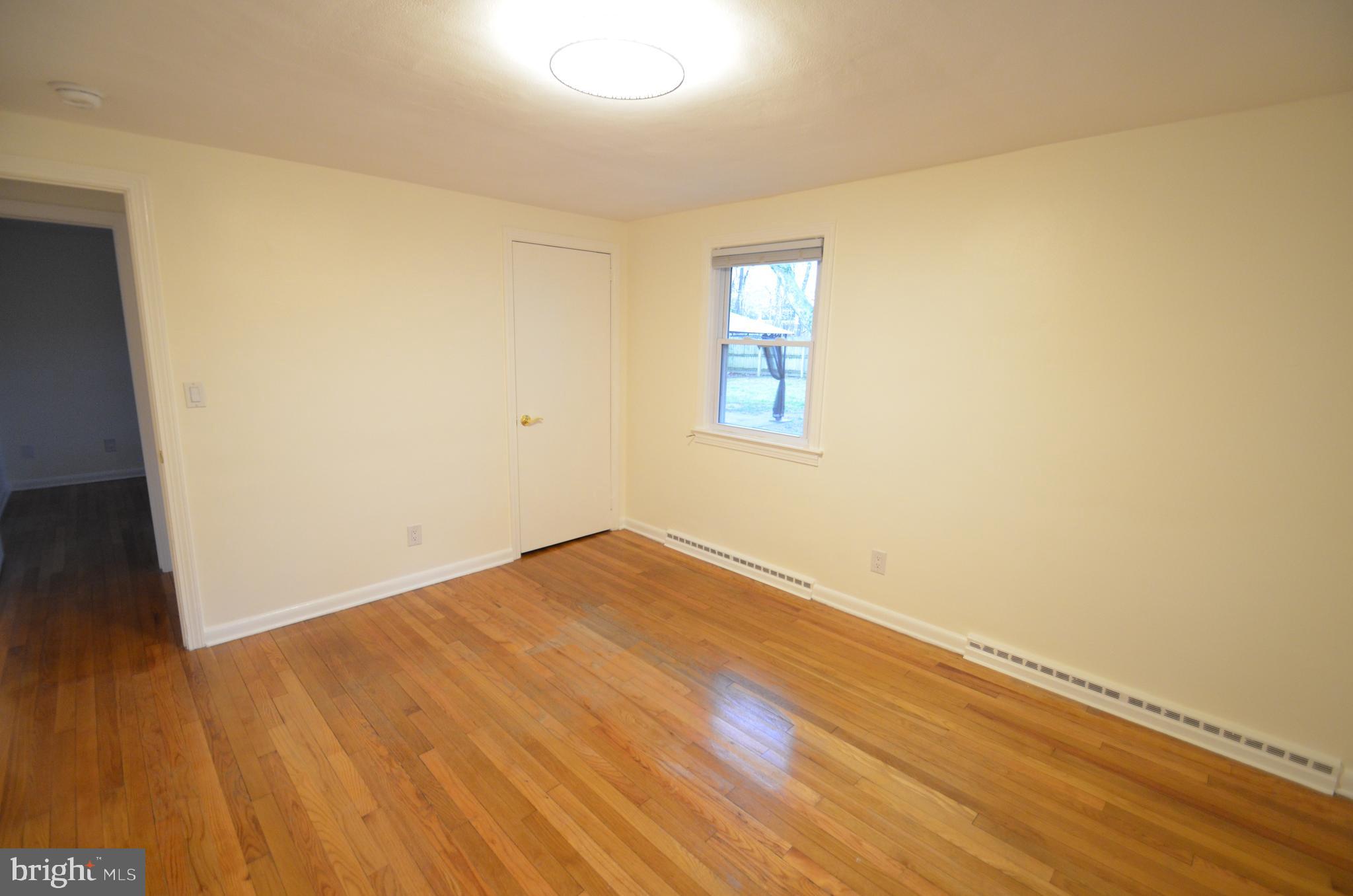 49 Wallace Road Princeton Junction, NJ 08550 - Photo 13 of 32 a view of an empty room with wooden floor and a window