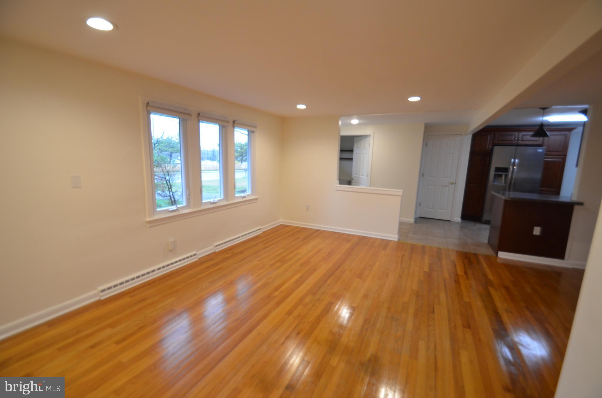 49 Wallace Road Princeton Junction, NJ 08550 - Photo 15 of 32 an empty room with wooden floor and windows