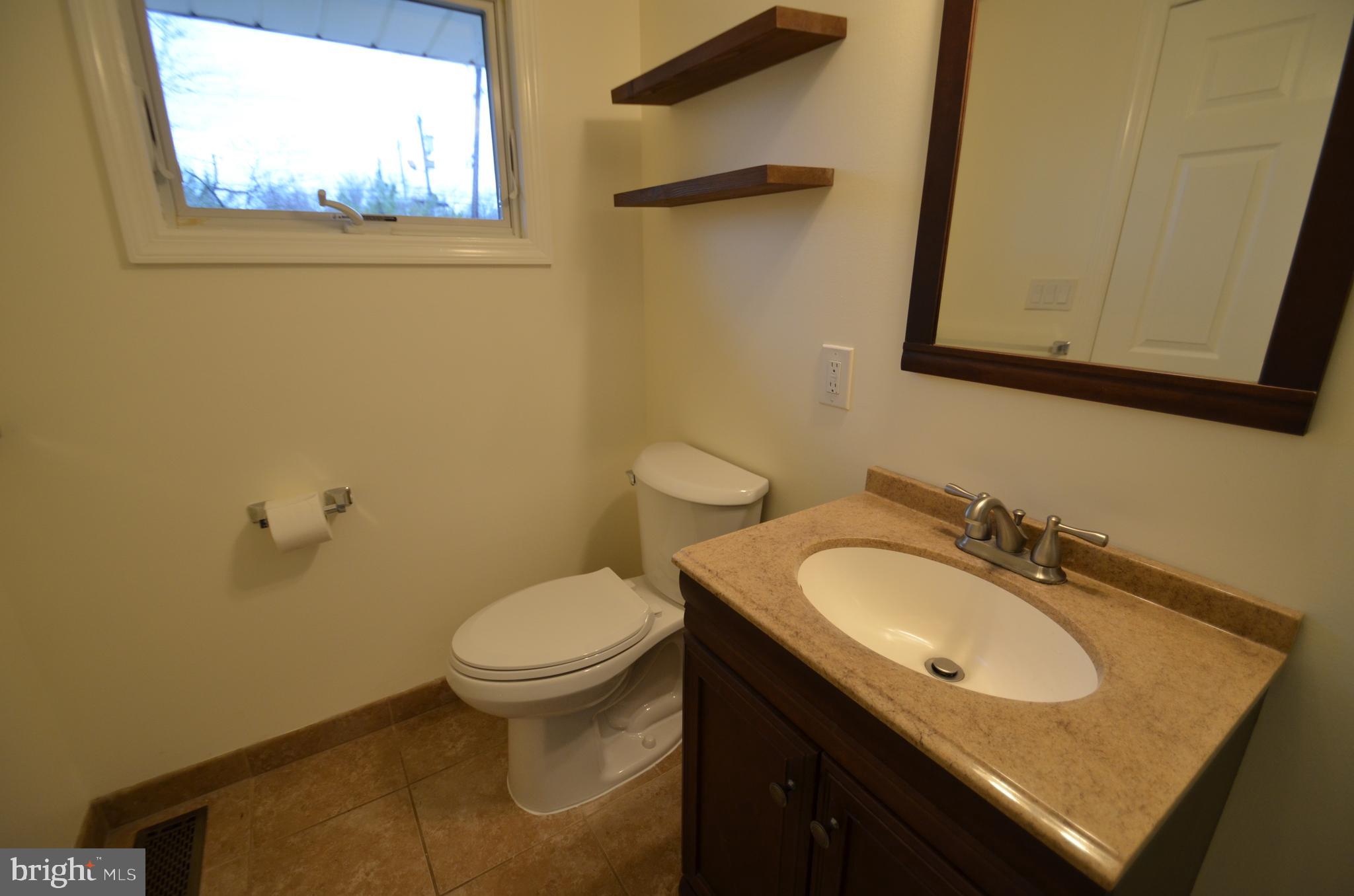 49 Wallace Road Princeton Junction, NJ 08550 - Photo 23 of 32 a bathroom with a granite countertop sink toilet and a mirror