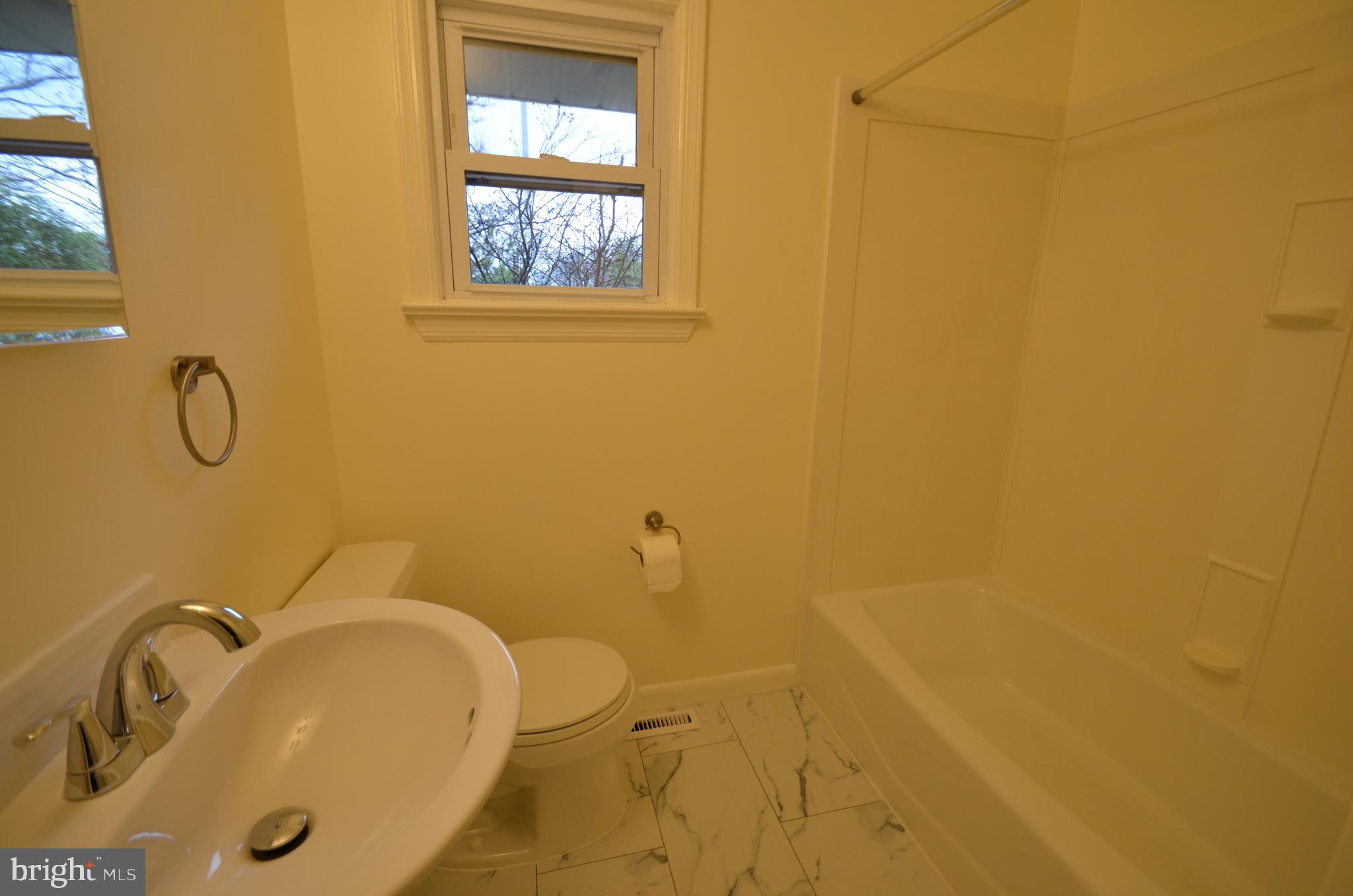 49 Wallace Road Princeton Junction, NJ 08550 - Photo 25 of 32 a bathroom with a tub sink and mirror