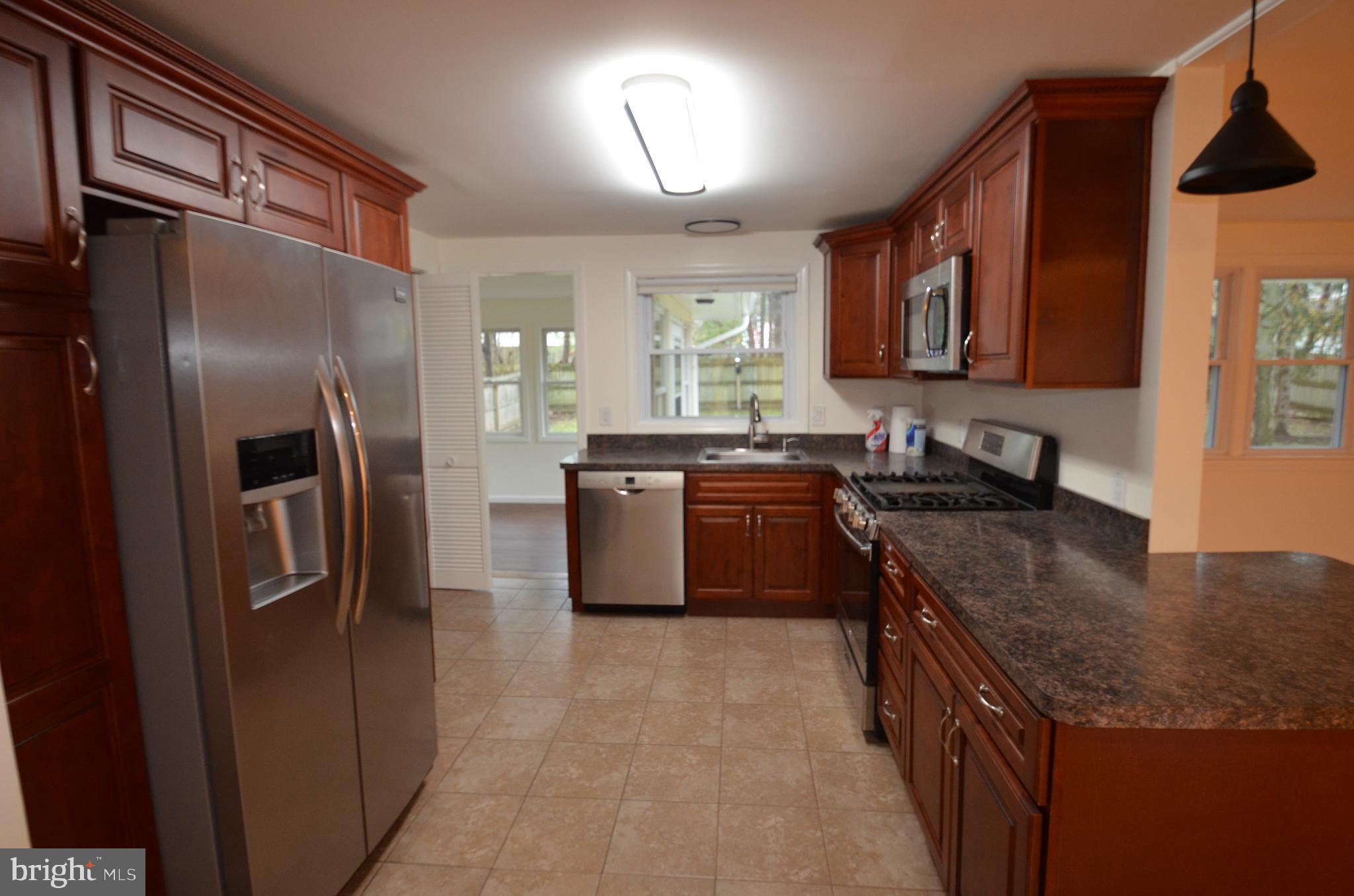 49 Wallace Road Princeton Junction, NJ 08550 - Photo 6 of 32 a kitchen with granite countertop a sink stainless steel appliances and cabinets