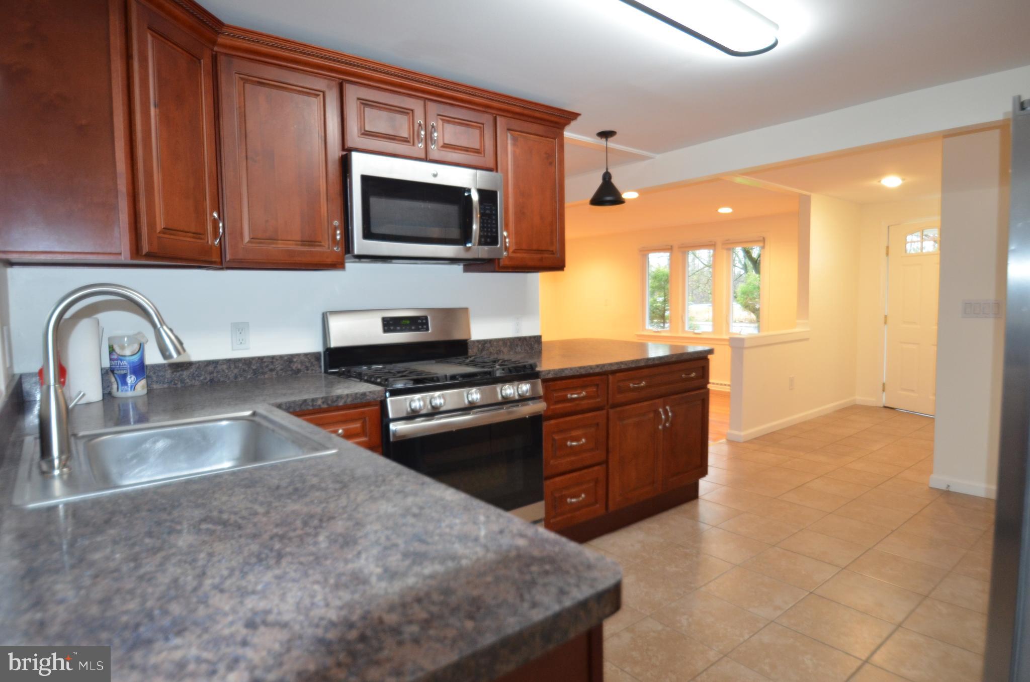 49 Wallace Road Princeton Junction, NJ 08550 - Photo 7 of 32 a kitchen with stainless steel appliances granite countertop a sink stove and microwave