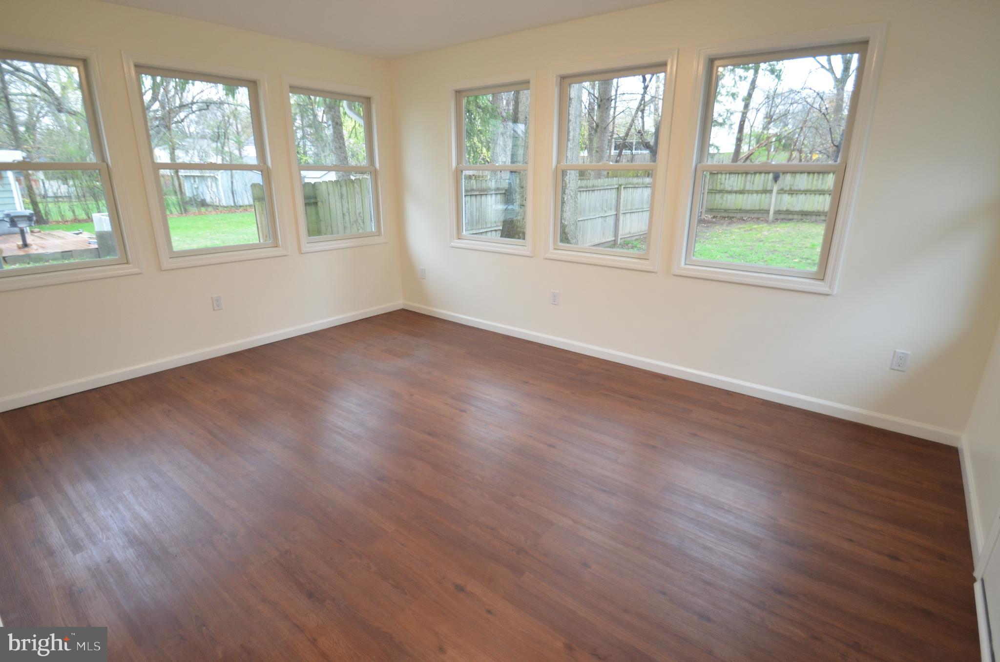 49 Wallace Road Princeton Junction, NJ 08550 - Photo 8 of 32 an empty room with wooden floor and windows