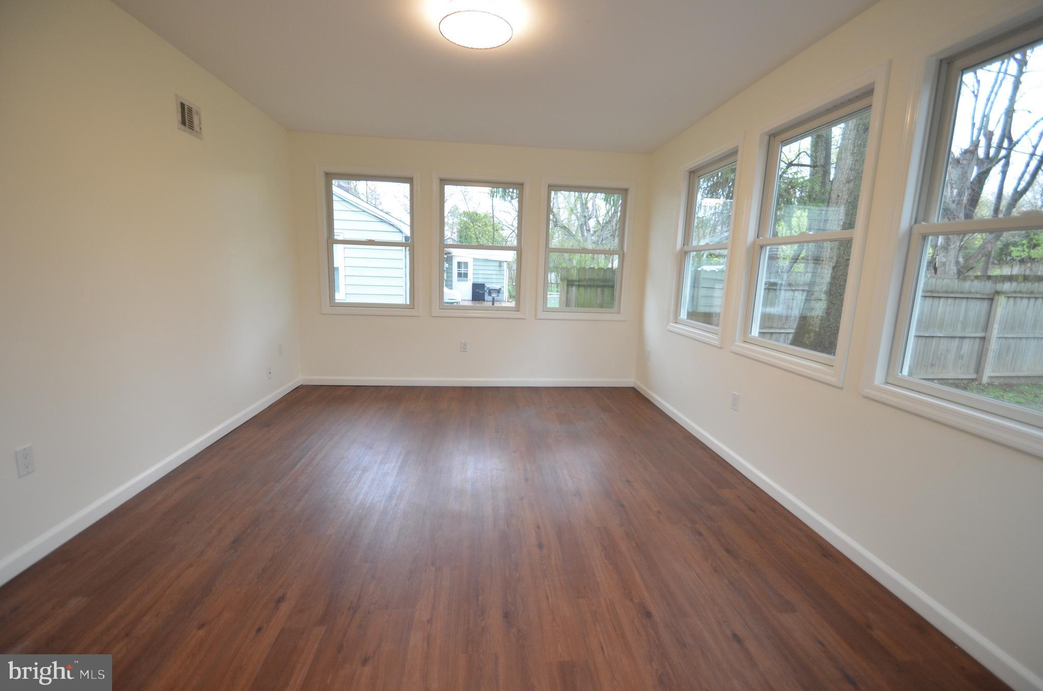 49 Wallace Road Princeton Junction, NJ 08550 - Photo 9 of 32 an empty room with wooden floor and windows