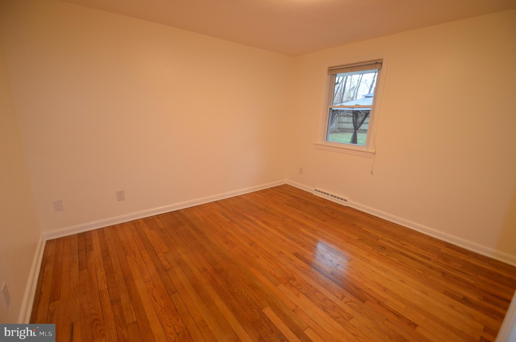 49 Wallace Road Princeton Junction, NJ 08550 - Photo 10 of 32 a view of empty room with wooden floor and fan