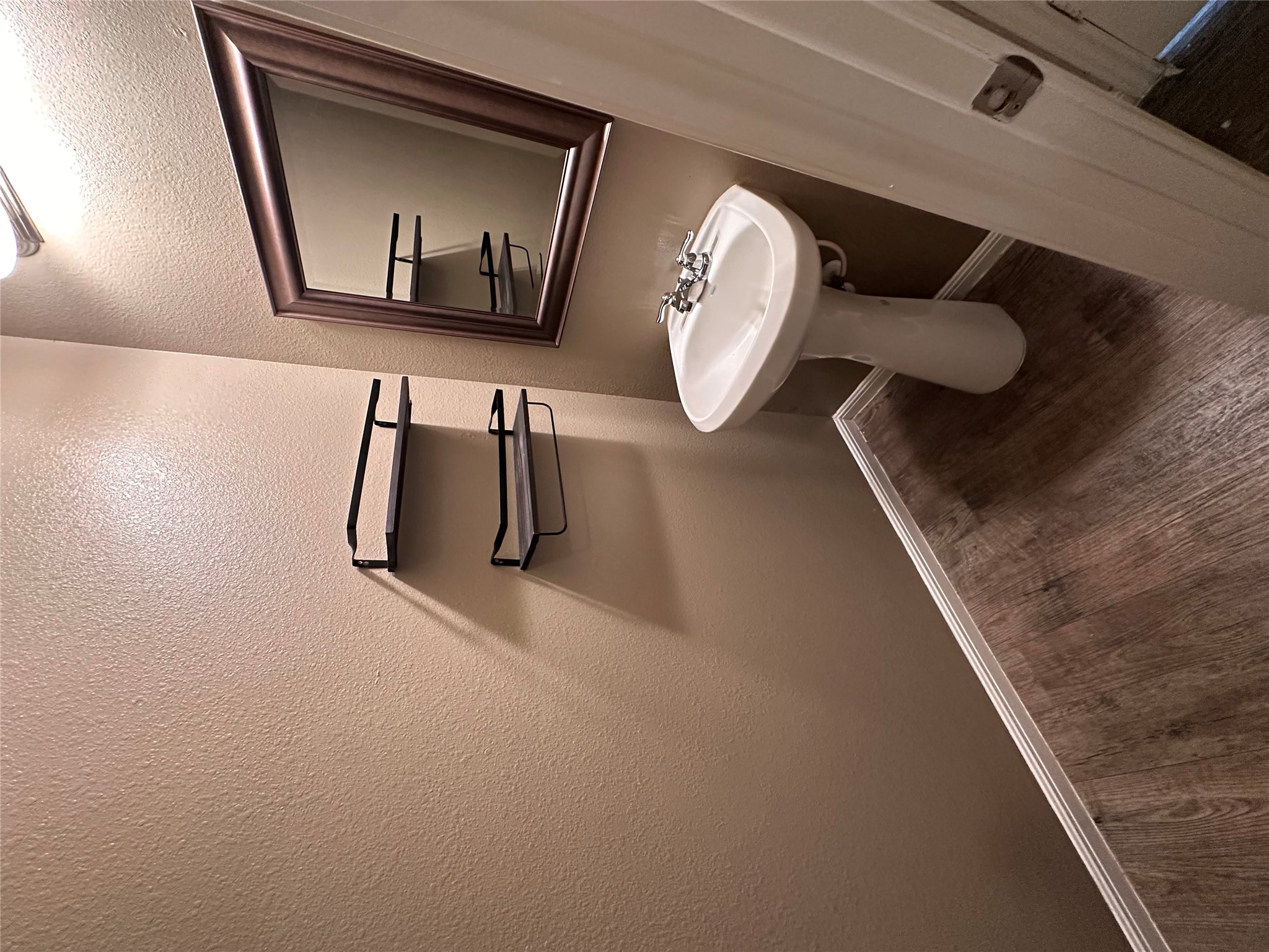 207 Liard River Road Hutto, TX 78634 - Photo 11 of 25 Bathroom with dark wood-style floors and a textured wall