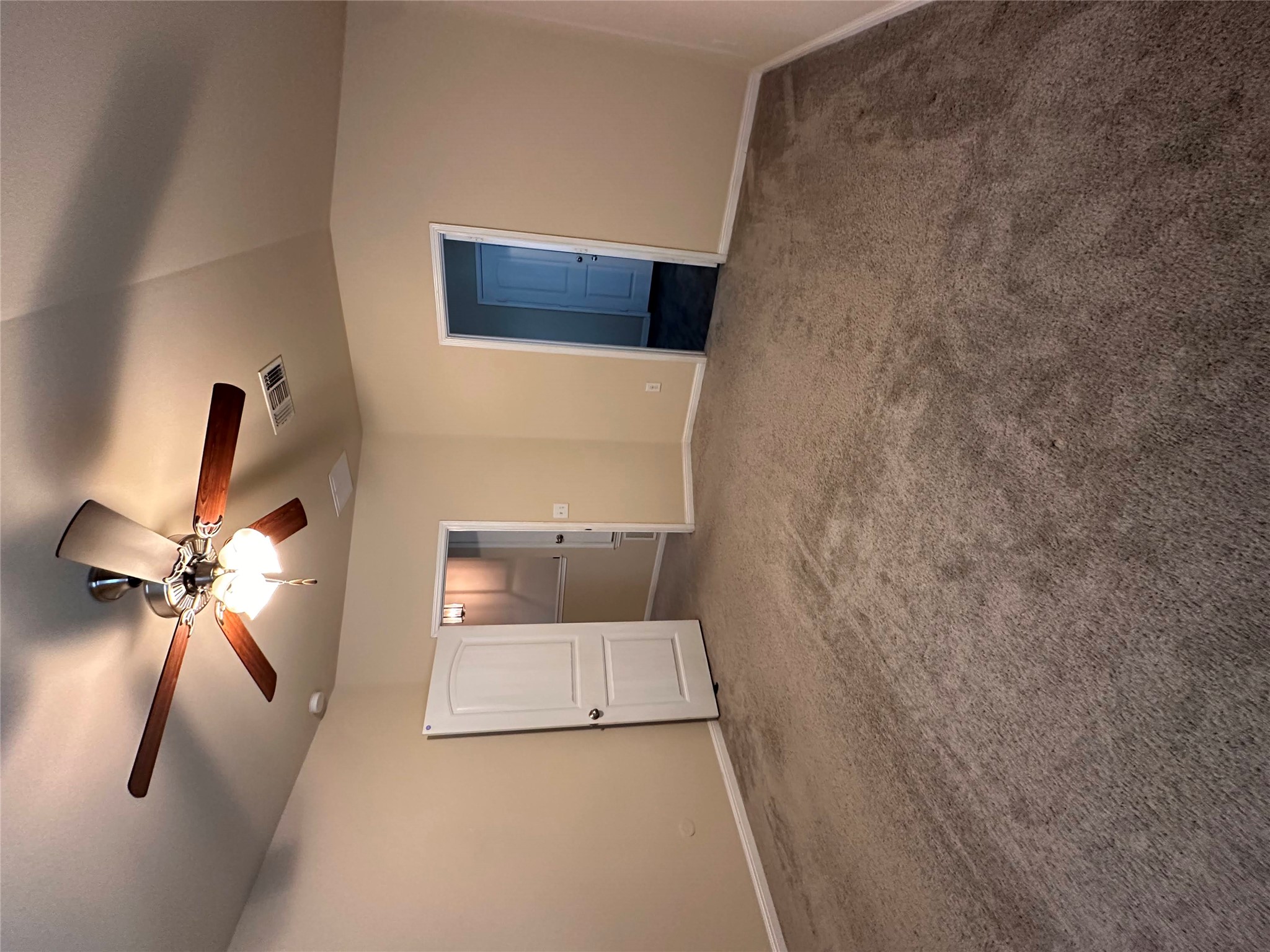 207 Liard River Road Hutto, TX 78634 - Photo 17 of 25 Unfurnished bedroom with a ceiling fan, dark colored carpet, and vaulted ceiling