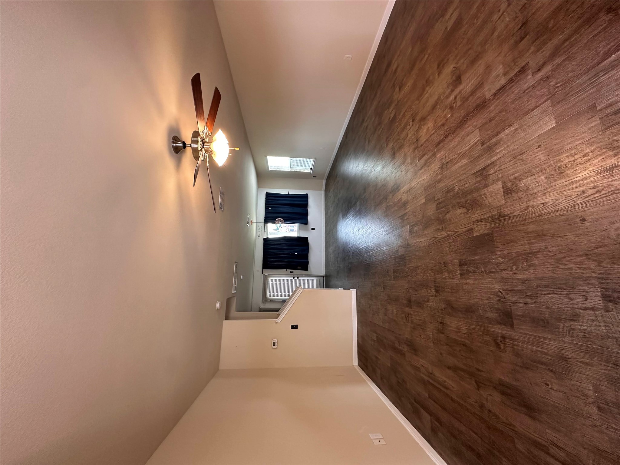 207 Liard River Road Hutto, TX 78634 - Photo 5 of 25 Unfurnished living room with dark wood finished floors and a ceiling fan