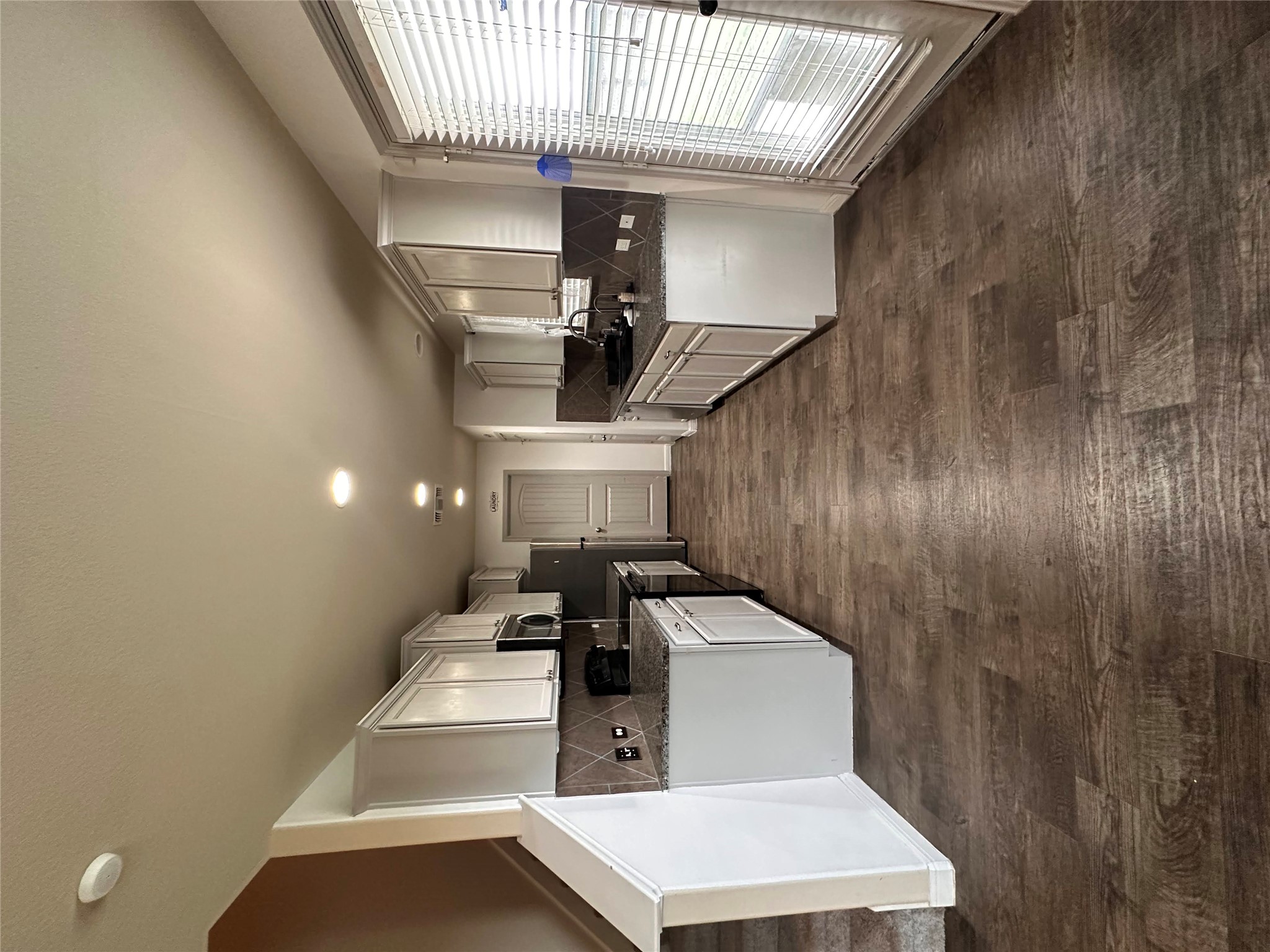207 Liard River Road Hutto, TX 78634 - Photo 8 of 25 Kitchen featuring stainless steel electric range oven, dark wood-type flooring, white cabinetry, backsplash, and recessed lighting