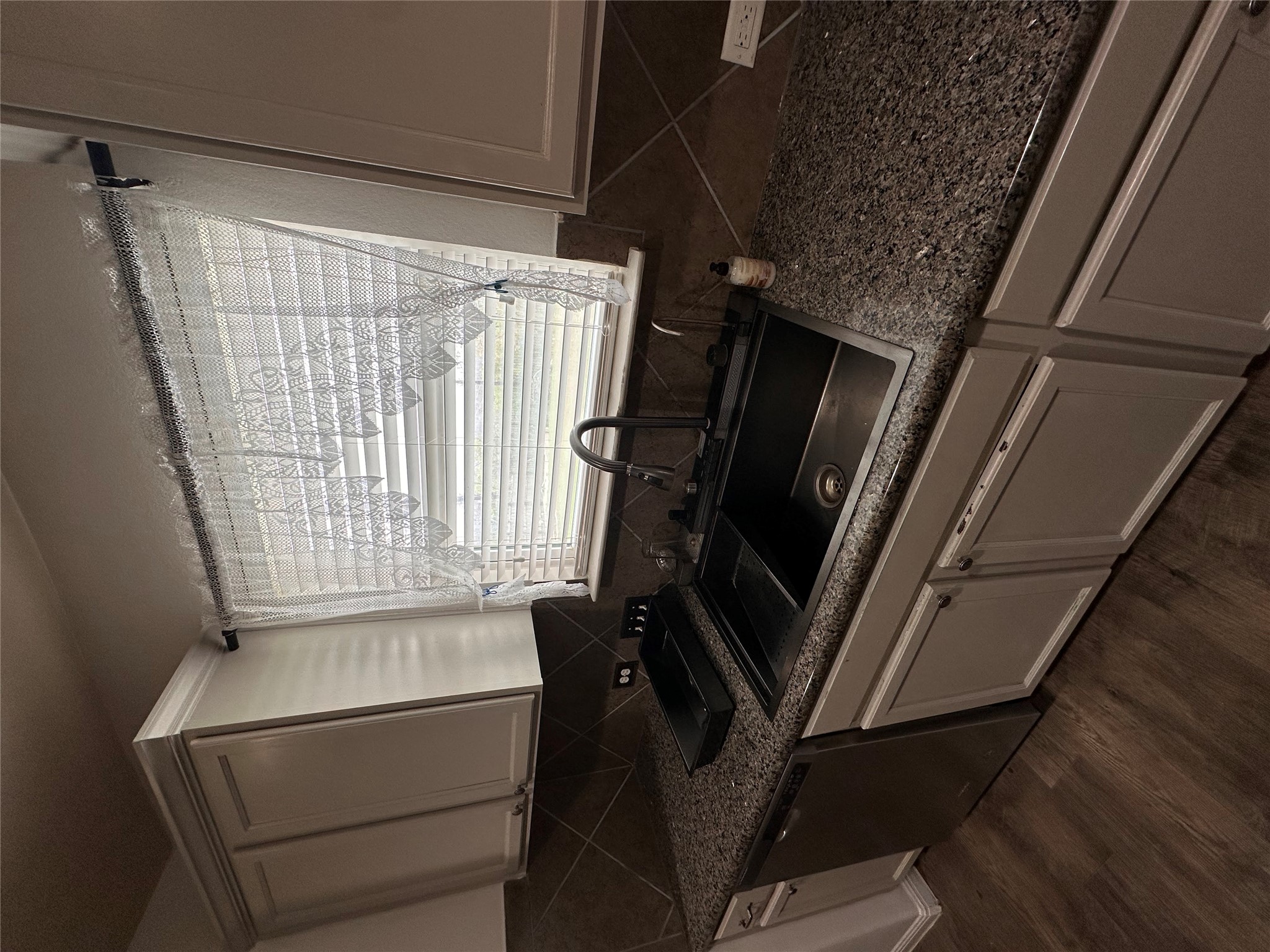 207 Liard River Road Hutto, TX 78634 - Photo 9 of 25 Kitchen featuring stainless steel dishwasher, dark wood-style flooring, and decorative backsplash