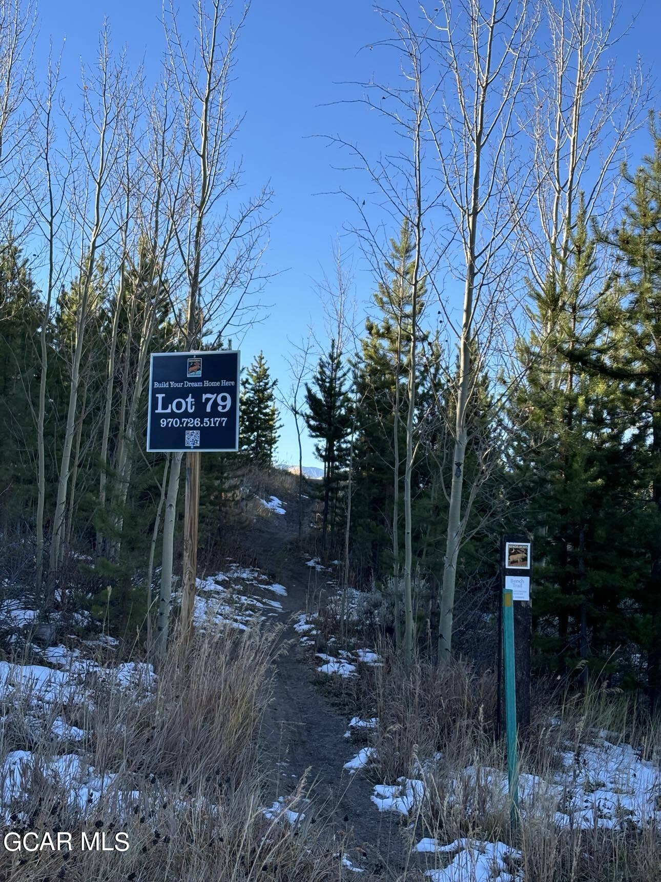 313 Bridger Trace Fraser, CO 80442 - Photo 3 of 3 a sign that is sitting in the middle of forest