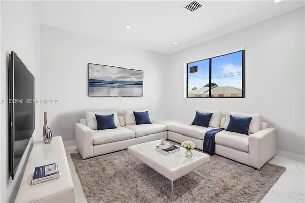 a living room with furniture and a rug