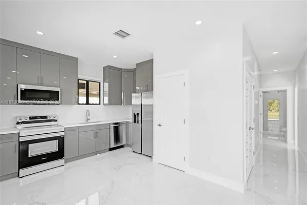 a view of a kitchen with washer and dryer