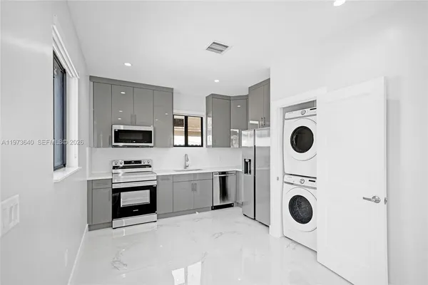 a view of a kitchen with a sink and a stove top oven